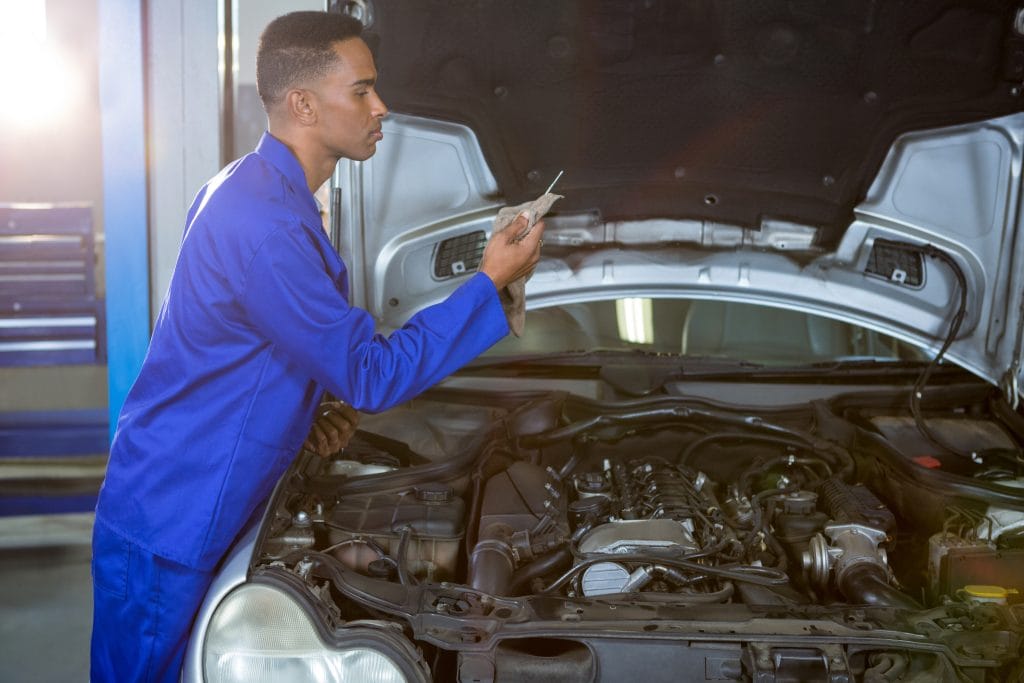 Mechanic wiping dipstick with napkin